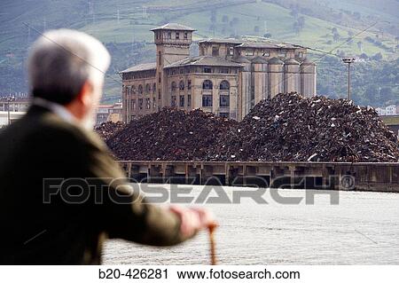 Stock Image - Junk metal piled up for iron foundry at port of Bilbao dock. Barakaldo, Biscay, Euskadi, Spain. Fotosearch