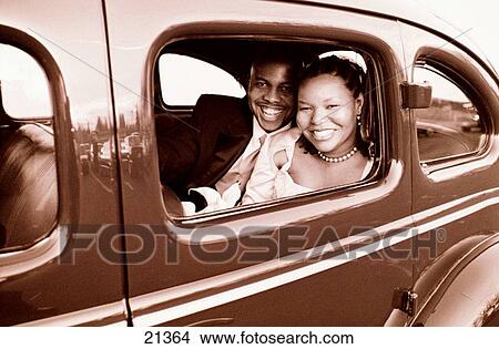Picture - Just married and off in a vintage car in black and white. Fotosearch