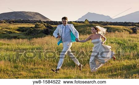 Stock Image - Just married couple, Snaefellsjokull Glacier in background, Iceland. Fotosearch