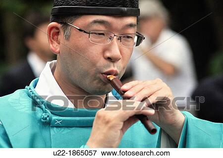 Kamakura, Kanagawa, Japan, Shinto monk playing a flute during a wedding ceremony at Tsurugaoka Hachiman-gu shrine View Large Photo Image Stock Photo - Kamakura, Kanagawa, Japan, Shinto monk playing a flute during a wedding ceremony at Tsurugaoka Hachiman-gu shrine. Fotosearch