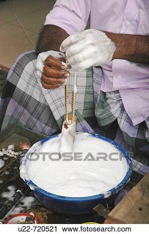 Kandy Sri Lanka: a goldsmith washing a gold necklace in the street View Large Photo Image Stock Image - Kandy Sri Lanka: a goldsmith washing a gold necklace in the street. Fotosearch