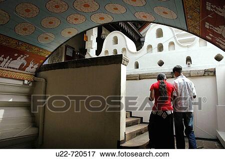 Kandy Sri Lanka: a young couple entering the Temple of the Tooth View Large Photo Image Stock Photo - Kandy Sri Lanka: a young couple entering the Temple of the Tooth. Fotosearch