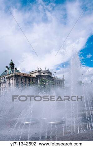 Stock Image - Karlsplatz Stachus fountain with the Palace of Justice, Munich, Germany. Fotosearch