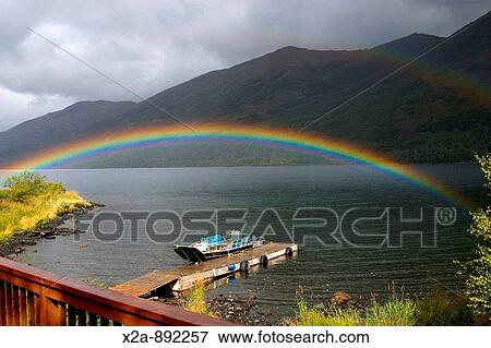 Stock Photo - KARLUK LAKE RAINBOW OVER BOAT. Fotosearch