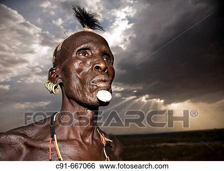 Stock Photograph - Karo man in the evening. South Ethiopia. African people. Fotosearch