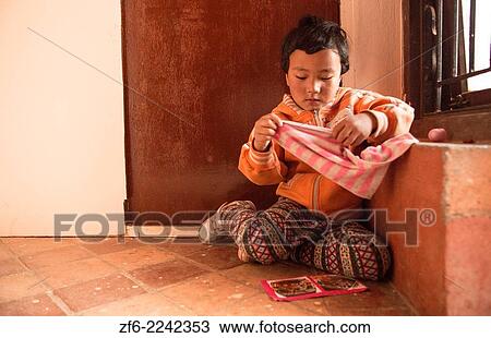 Kathmandu Nepal. Nepali child age 4 plays and poses for camera in Nayapati Eastern Kathmandu. 1. View Large Photo Image Stock Image - Kathmandu Nepal. Nepali child age 4 plays and poses for camera in Nayapati Eastern Kathmandu. 1.. Fotosearch