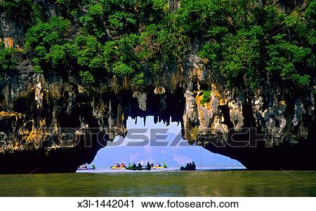 Kayaker paddles through a Tam Rod cave in en Parque Nacional de Ao Phang-Nga National Park Thailand View Large Photo Image Stock Image - Kayaker paddles through a Tam Rod cave in en Parque Nacional de Ao Phang-Nga National Park Thailand. Fotosearch