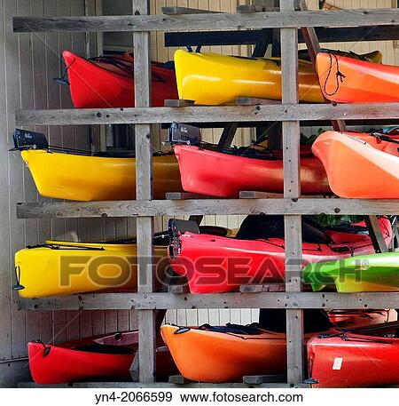 Kayaks stacked on a rack out of water. View Large Photo Image Stock Photo - Kayaks stacked on a rack out of water.. Fotosearch
