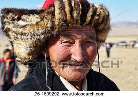 Stock Image - Kazakh eagle hunter in the Altai Region of Bayan-? lgii in Western Mongolia. Fotosearch
