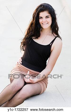 Stock Photo - Keen young woman is showing finger. Fotosearch