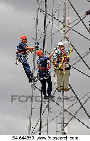Stock Photo - Kenosha Wisconsin based Coast Guard practice climbing technique on a tower during a training session. Fotosearch