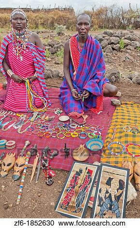 Kenya Africa Amboseli Maasai tribe village Masai in red costumes dress seeing souvenirs in remote area of Amboseli National Park safari 1 View Large Photo Image Stock Image - Kenya Africa Amboseli Maasai tribe village Masai in red costumes dress seeing souvenirs in remote area of Amboseli National Park safari 1. Fotosearch