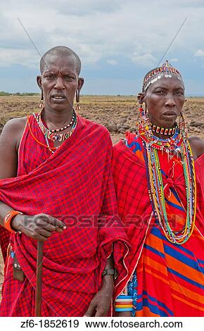 Kenya Africa Amboseli Masai man and woman in red costume dress and beads in Amboseli National Park safari out alone in jungle 1 View Large Photo Image Stock Photo - Kenya Africa Amboseli Masai man and woman in red costume dress and beads in Amboseli National Park safari out alone in jungle 1. Fotosearch