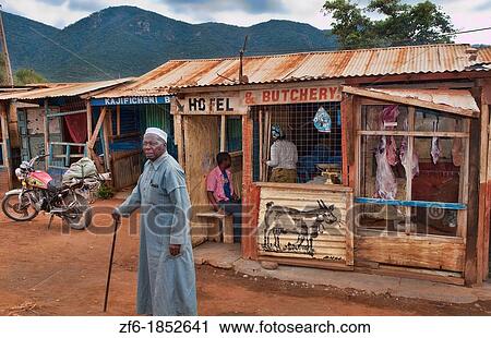 Kenya Africa Namanga border town stores and shops of cheap hotel and butchery with local people in poor village View Large Photo Image Stock Image - Kenya Africa Namanga border town stores and shops of cheap hotel and butchery with local people in poor village. Fotosearch