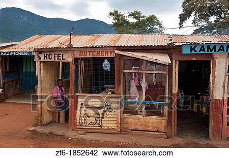 Kenya Africa Namanga border town stores and shops of cheap hotel and butchery with local people in poor village View Large Photo Image Stock Image - Kenya Africa Namanga border town stores and shops of cheap hotel and butchery with local people in poor village. Fotosearch