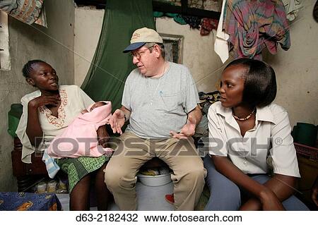 Stock Image - KENYA. American Catholic missionary visiting poor people with HIV AIDS, Mombasa.. Fotosearch