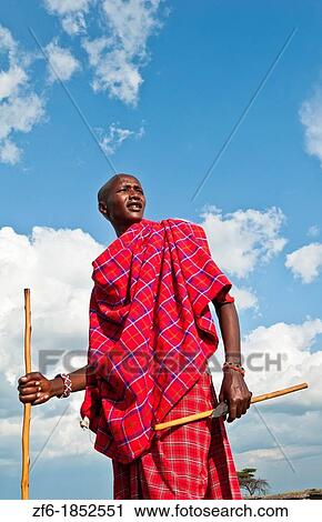 Kenya Masai Mara Masai warrior in red traditional wrap and stick in Masai Mara National Park in reserve 9 View Large Photo Image Stock Image - Kenya Masai Mara Masai warrior in red traditional wrap and stick in Masai Mara National Park in reserve 9. Fotosearch