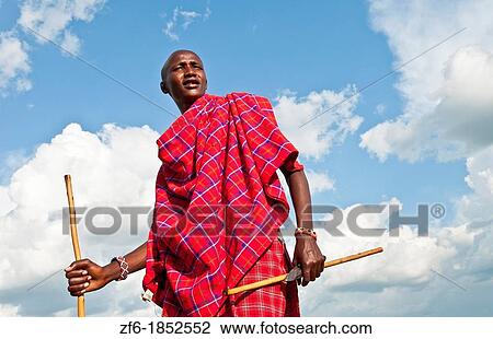 Kenya Masai Mara Masai warrior in red traditional wrap and stick in Masai Mara National Park in reserve 9 View Large Photo Image Stock Image - Kenya Masai Mara Masai warrior in red traditional wrap and stick in Masai Mara National Park in reserve 9. Fotosearch