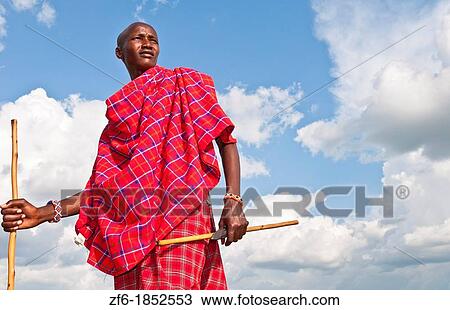Kenya Masai Mara Masai warrior in red traditional wrap and stick in Masai Mara National Park in reserve 9 View Large Photo Image Stock Image - Kenya Masai Mara Masai warrior in red traditional wrap and stick in Masai Mara National Park in reserve 9. Fotosearch