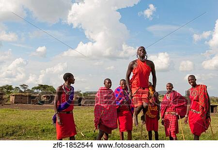 Kenya Masai Mara Masai warriors doing traditional jumping for tourists in Masai Mara National Park in reserve 9 View Large Photo Image Picture - Kenya Masai Mara Masai warriors doing traditional jumping for tourists in Masai Mara National Park in reserve 9. Fotosearch