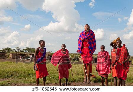 Stock Photography - Kenya Masai Mara Masai warriors doing traditional jumping for tourists in Masai Mara National Park in reserve 9. Fotosearch