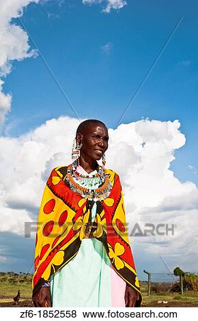 Kenya Masai Mara reserve with Masai woman in colorful dress with blue sky in Masai Mara National Park in reserve 10 View Large Photo Image Stock Photo - Kenya Masai Mara reserve with Masai woman in colorful dress with blue sky in Masai Mara National Park in reserve 10. Fotosearch