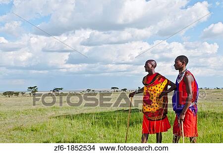 Kenya Masai Mara reserve with space and two Masai warriors and clouds in Masai Mara National Park in reserve 8 View Large Photo Image Picture - Kenya Masai Mara reserve with space and two Masai warriors and clouds in Masai Mara National Park in reserve 8. Fotosearch