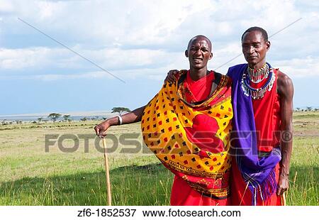 Stock Photo - Kenya Masai Mara reserve with space and two Masai warriors and clouds in Masai Mara National Park in reserve 8. Fotosearch