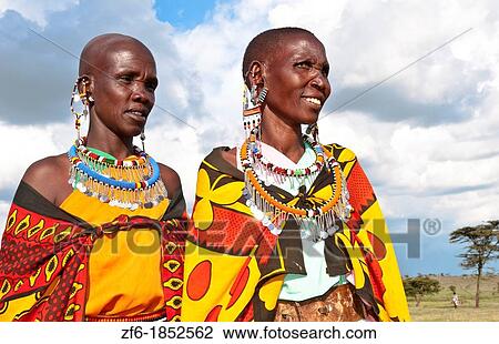 Kenya Masai Mara reserve with two Masai women in colorful dress with blue sky in Masai Mara National Park in reserve 10 View Large Photo Image Stock Image - Kenya Masai Mara reserve with two Masai women in colorful dress with blue sky in Masai Mara National Park in reserve 10. Fotosearch