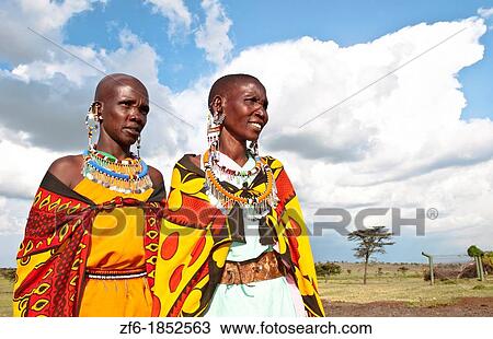 Kenya Masai Mara reserve with two Masai women in colorful dress with blue sky in Masai Mara National Park in reserve 10 View Large Photo Image Stock Image - Kenya Masai Mara reserve with two Masai women in colorful dress with blue sky in Masai Mara National Park in reserve 10. Fotosearch