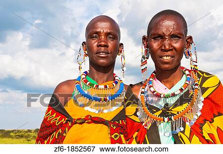 Kenya Masai Mara reserve with two Masai women in colorful dress with blue sky in Masai Mara National Park in reserve 10 View Large Photo Image Stock Photo - Kenya Masai Mara reserve with two Masai women in colorful dress with blue sky in Masai Mara National Park in reserve 10. Fotosearch