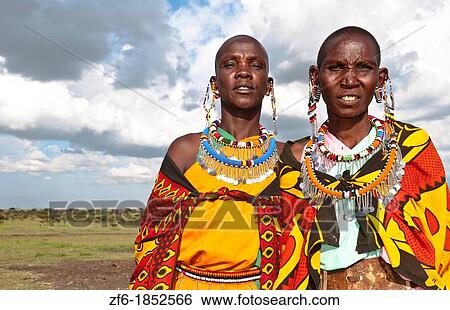 Kenya Masai Mara reserve with two Masai women in colorful dress with blue sky in Masai Mara National Park in reserve 10 View Large Photo Image Stock Photograph - Kenya Masai Mara reserve with two Masai women in colorful dress with blue sky in Masai Mara National Park in reserve 10. Fotosearch