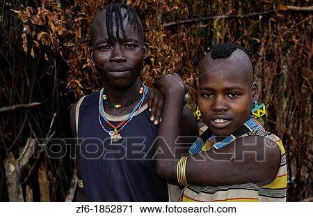 Key Afer Ethiopia Africa village Lower Omo Valley portrait closeup of Bena tribe couple man and woman with beads and traditional outfits 14 View Large Photo Image Stock Image - Key Afer Ethiopia Africa village Lower Omo Valley portrait closeup of Bena tribe couple man and woman with beads and traditional outfits 14. Fotosearch