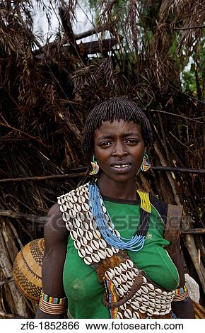 Stock Photograph - Key Afer Ethiopia Africa village Lower Omo Valley closeup of a Hamar or Hammer woman traditional outfits and red hair portrait 14. Fotosearch