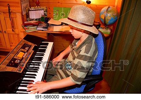 Keyboard playing boy View Large Photo Image Stock Image - Keyboard playing boy. Fotosearch
