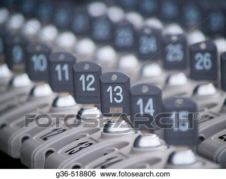 Stock Photograph - Keys lined up in a rack for locking umbrellas up outside a Temple in Kyoyo, Japan. Fotosearch