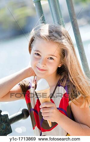 Kid girl and an ice-cream View Large Photo Image Stock Photo - Kid girl and an ice-cream. Fotosearch