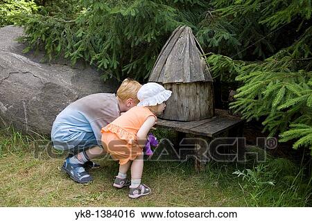 Kid Girl and Boy Looking Small Fairy-Tale House at Pokumaa, V? ru County, Estonia View Large Photo Image Stock Photograph - Kid Girl and Boy Looking Small Fairy-Tale House at Pokumaa, V? ru County, Estonia. Fotosearch