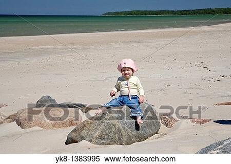 Kid Girl Sitting on Stone by Baltic Sea Beach in V??na-J? esuu, Estonia View Large Photo Image Stock Photography - Kid Girl Sitting on Stone by Baltic Sea Beach in V??na-J? esuu, Estonia. Fotosearch