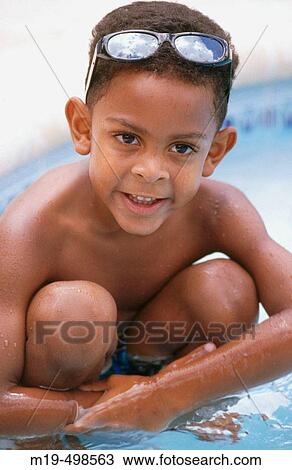 Stock Image - kid in a swiming pool. Fotosearch