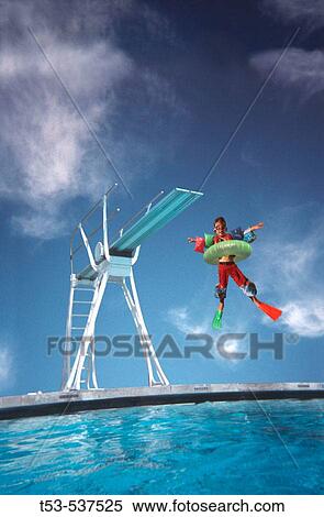 Stock Photography - Kid in full flotation jumps from high dive board.. Fotosearch