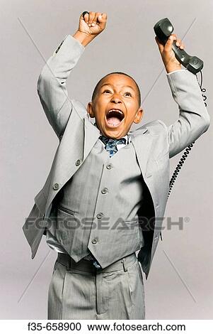 Kid in suit on phone View Large Photo Image Stock Image - Kid in suit on phone. Fotosearch
