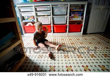 Stock Image - kid playing in a room. Fotosearch
