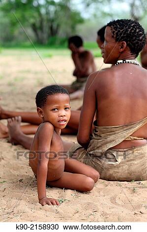 Kid sitting besides his mother, Namibia, Africa. View Large Photo Image Stock Image - Kid sitting besides his mother, Namibia, Africa.. Fotosearch