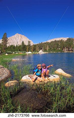 Kids (ages 5 & 9) exploring the shore of Muir Lake, John Muir Wilderness, Sierra Nevada Mountains, California USA. View Large Photo Image Stock Photograph - Kids (ages 5 & 9) exploring the shore of Muir Lake, John Muir Wilderness, Sierra Nevada Mountains, California USA.. Fotosearch