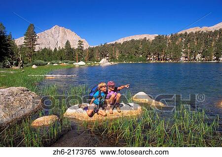 Kids (ages 5 & 9) exploring the shore of Muir Lake, John Muir Wilderness, Sierra Nevada Mountains, California USA. View Large Photo Image Stock Photography - Kids (ages 5 & 9) exploring the shore of Muir Lake, John Muir Wilderness, Sierra Nevada Mountains, California USA.. Fotosearch