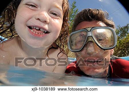 Kids and dads who do swim in the pool in the garden View Large Photo Image Stock Photo - Kids and dads who do swim in the pool in the garden. Fotosearch