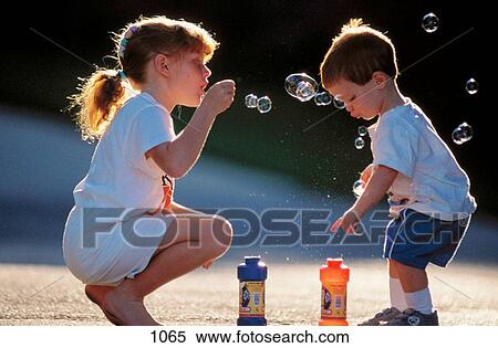 Kids blowing bubbles View Large Photo Image Stock Photography - Kids blowing bubbles. Fotosearch