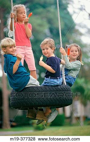kids eating popsicles on a tire swing View Large Photo Image Stock Photo - kids eating popsicles on a tire swing. Fotosearch