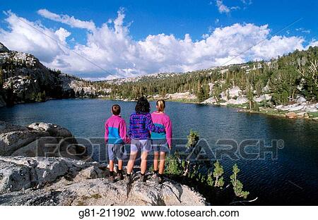 Kids enjoying the view along the shore of Boothe Lake, in the Cathedral Range, Sierra Nevada Mountains. Yosemite NP. California. USA View Large Photo Image Stock Image - Kids enjoying the view along the shore of Boothe Lake, in the Cathedral Range, Sierra Nevada Mountains. Yosemite NP. California. USA. Fotosearch